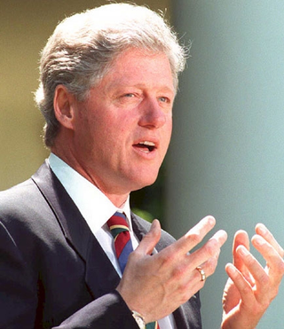 At a White House press conference, President Clinton explains the details of his new "Forget About All That 21st Century Bridge Crap" plan.